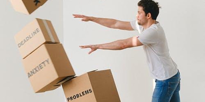 Man pushing over cardboard boxes