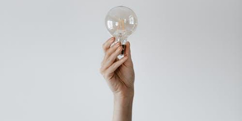 hand holding up light bulb