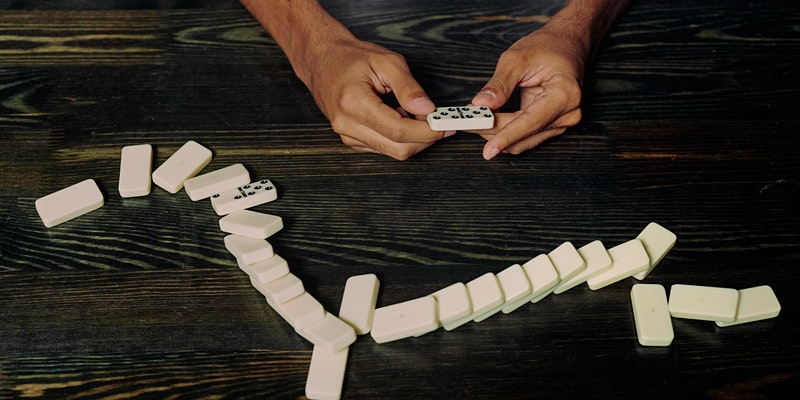 hands holding dominoes